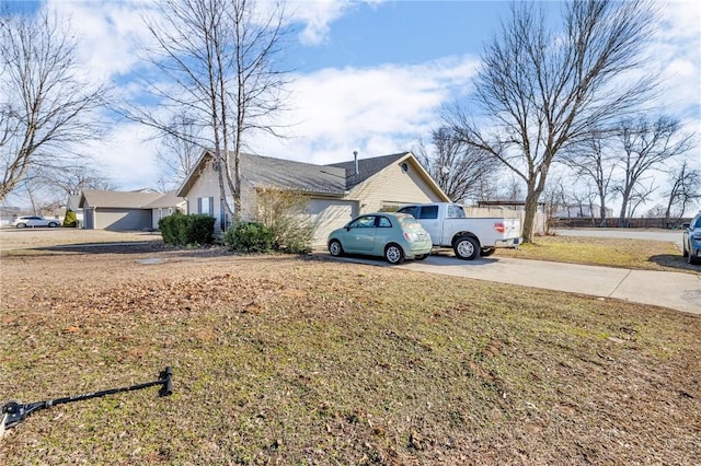 view of side of property with a garage and a yard