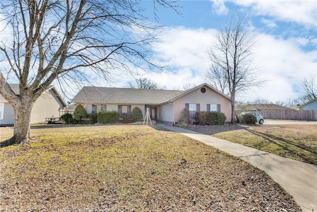 ranch-style home featuring a front yard