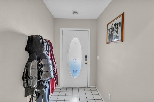 foyer entrance with light tile patterned floors