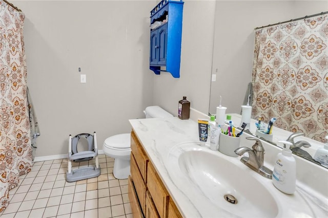 bathroom featuring vanity, tile patterned floors, and toilet