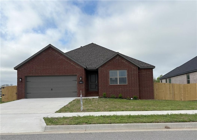 ranch-style house with fence, a front lawn, concrete driveway, brick siding, and a garage