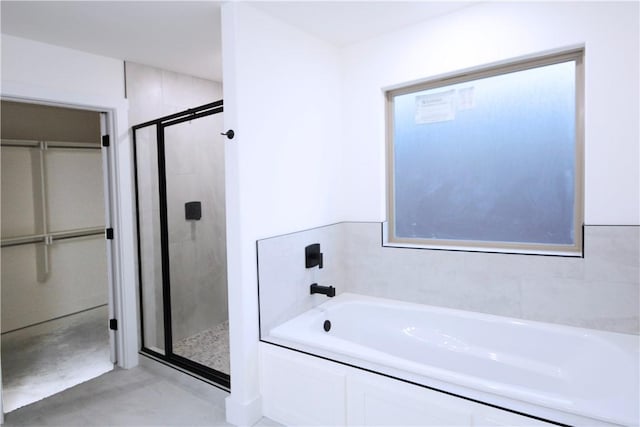 bathroom with shower with separate bathtub