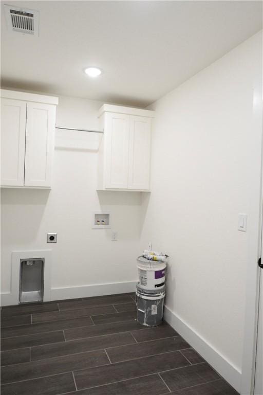 washroom featuring cabinets, washer hookup, and electric dryer hookup