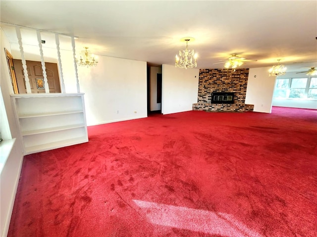 unfurnished living room featuring carpet floors, a fireplace, and ceiling fan with notable chandelier