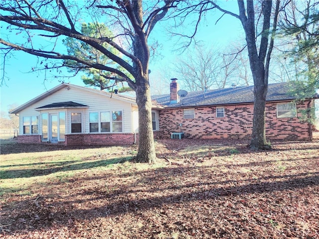 exterior space featuring cooling unit and a lawn