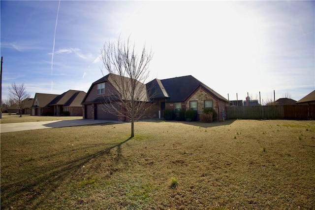 ranch-style house featuring a garage and a front yard