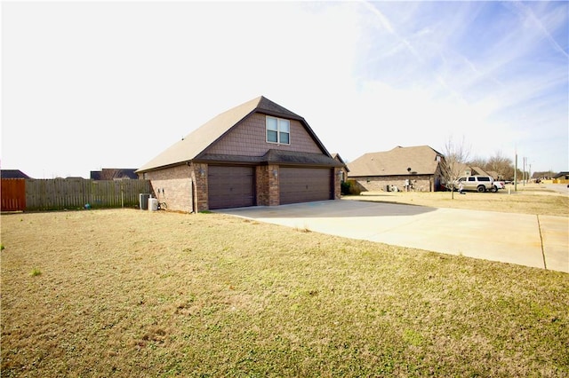 view of side of property featuring a garage and a lawn