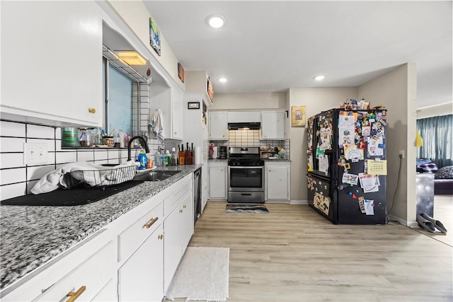 kitchen with decorative backsplash, appliances with stainless steel finishes, under cabinet range hood, white cabinetry, and a sink