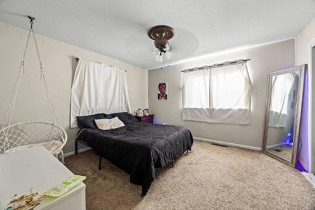 bedroom with carpet floors, baseboards, visible vents, and ceiling fan