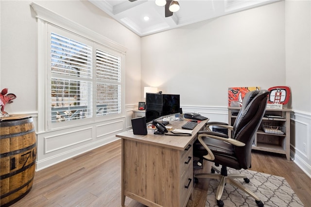 office space with beamed ceiling, hardwood / wood-style flooring, ornamental molding, coffered ceiling, and ceiling fan