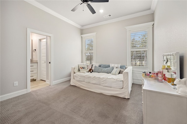 bedroom featuring ceiling fan, ensuite bath, ornamental molding, and carpet