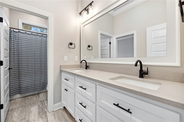 bathroom featuring vanity, crown molding, and a shower with shower curtain