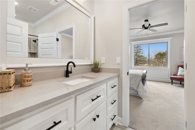 bathroom with ceiling fan, ornamental molding, and vanity