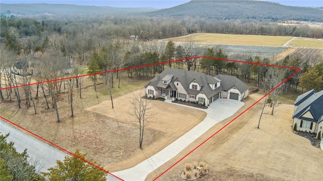 drone / aerial view featuring a mountain view and a rural view