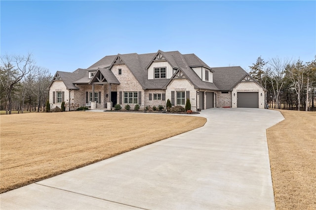 french country home with a garage and a front yard