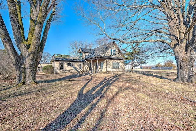 view of front of home featuring a front lawn and solar panels