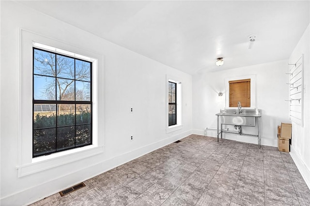 unfurnished living room with plenty of natural light