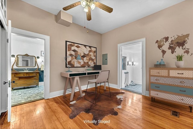 office featuring hardwood / wood-style flooring, ceiling fan, and electric panel