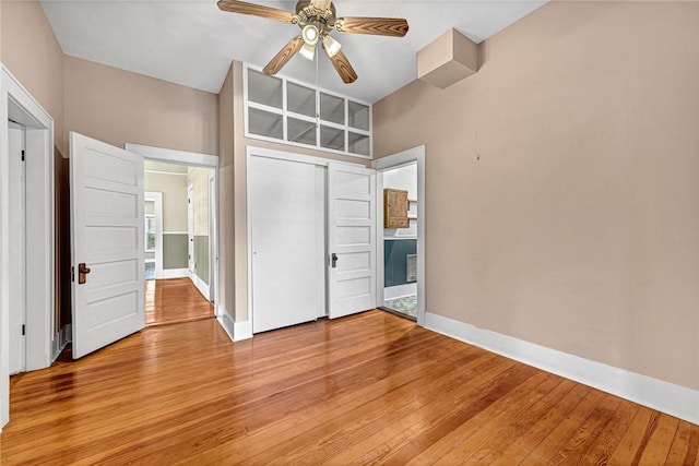 unfurnished bedroom with vaulted ceiling, ceiling fan, light hardwood / wood-style floors, and a closet