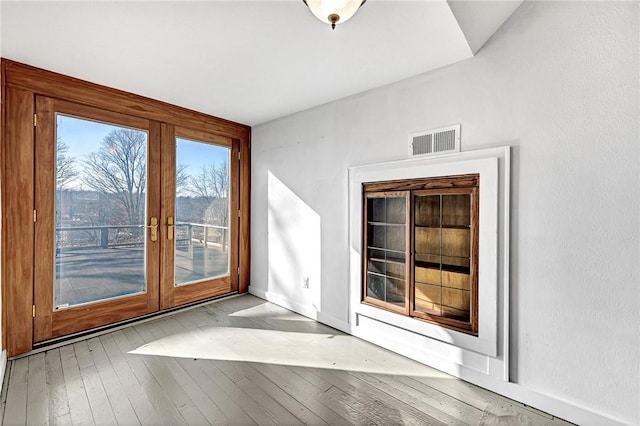 interior space with french doors and light wood-type flooring