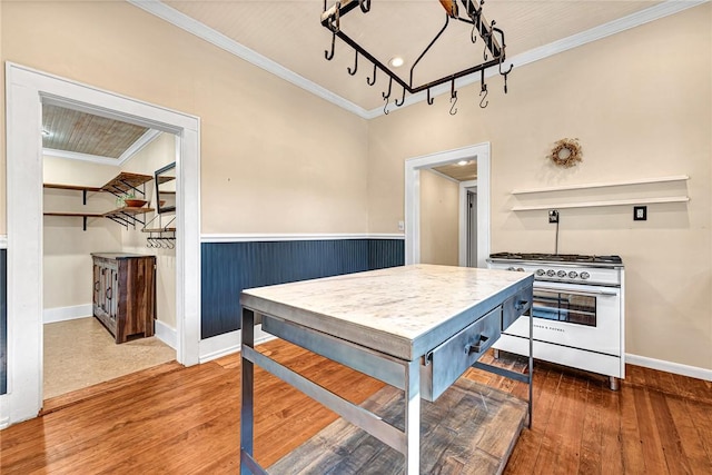 kitchen featuring high end stainless steel range oven, crown molding, and dark wood-type flooring