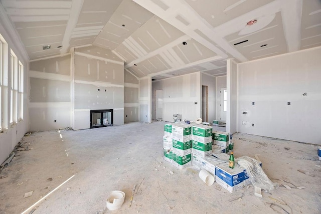 unfurnished living room featuring a fireplace and vaulted ceiling