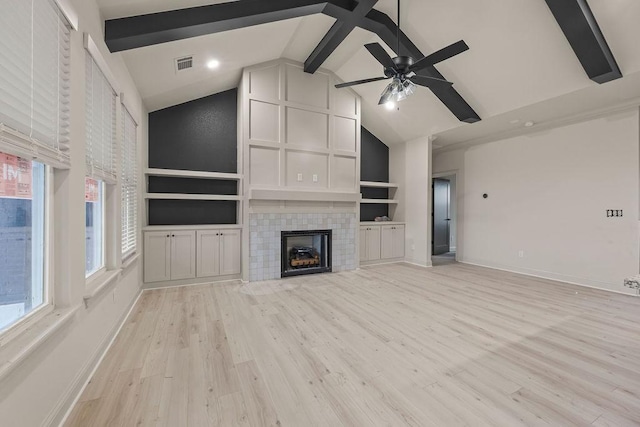 7967 Range Ave, Springdale, AR 72762 - unfurnished living room with beam ceiling, baseboards, high vaulted ceiling, a tiled fireplace, and light wood finished floors