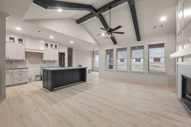 7967 Range Ave, Springdale, AR 72762 - kitchen featuring a ceiling fan, white cabinets, a tile fireplace, light wood-style floors, and a center island