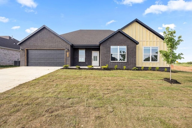 7967 Range Ave, Springdale, AR 72762 - view of front of property featuring board and batten siding, a garage, central AC, concrete driveway, and a front yard