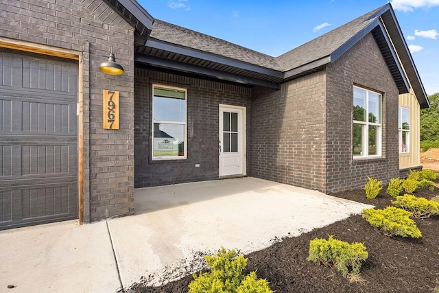 7967 Range Ave, Springdale, AR 72762 - entrance to property featuring brick siding, an attached garage, and a shingled roof