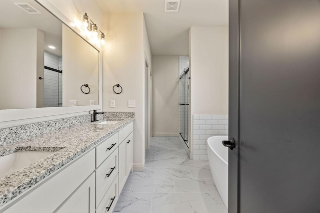 7967 Range Ave, Springdale, AR 72762 - bathroom featuring marble look tile flooring, a soaking tub, double vanity, a shower stall, and recessed lighting