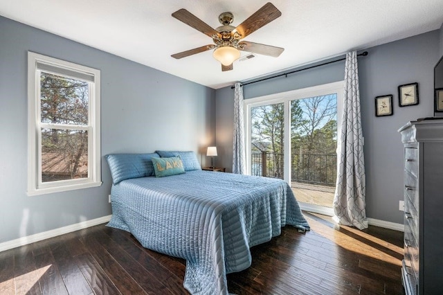 bedroom with access to exterior, ceiling fan, dark hardwood / wood-style floors, and multiple windows