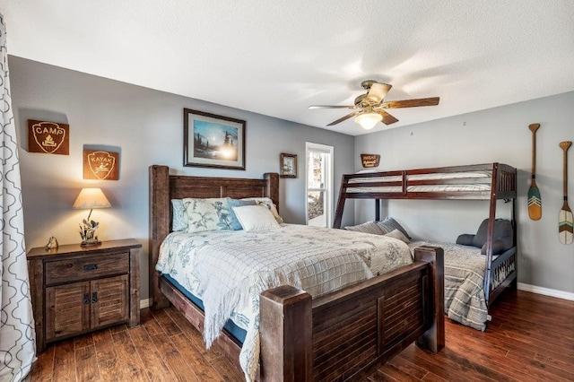 bedroom featuring ceiling fan, dark hardwood / wood-style flooring, and a textured ceiling