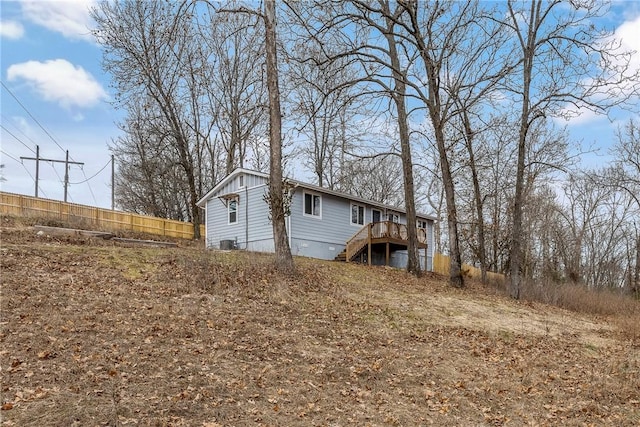 view of side of property featuring a wooden deck