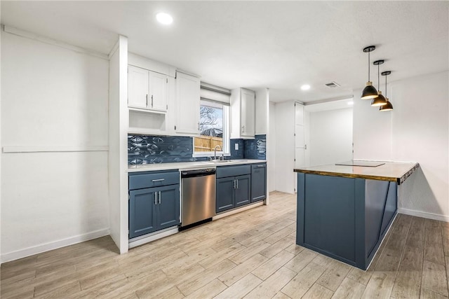 kitchen featuring blue cabinets, white cabinetry, tasteful backsplash, decorative light fixtures, and stainless steel dishwasher