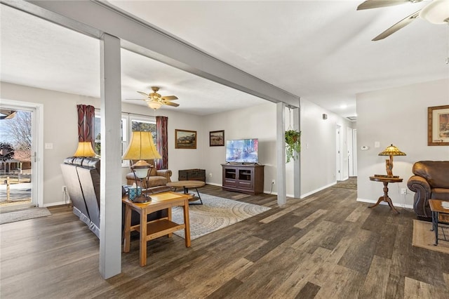 living room with dark wood-type flooring and ceiling fan