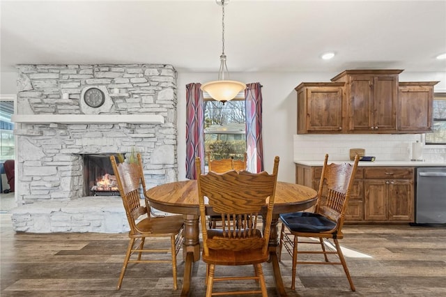 dining area with hardwood / wood-style flooring and a fireplace