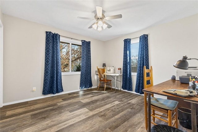 home office featuring dark wood-type flooring and ceiling fan