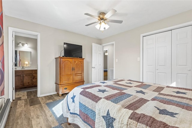 bedroom featuring hardwood / wood-style flooring, ceiling fan, connected bathroom, and a closet