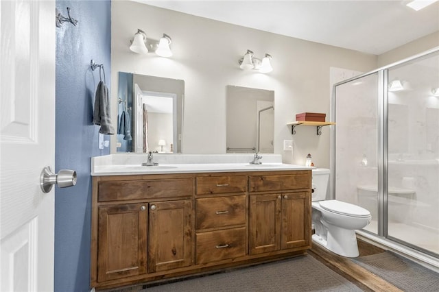 bathroom with vanity, toilet, and an enclosed shower