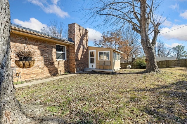 back of house featuring a yard