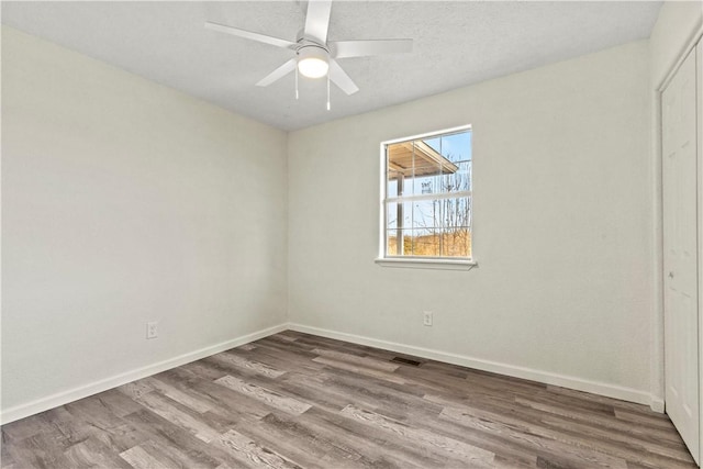 empty room featuring ceiling fan and hardwood / wood-style floors