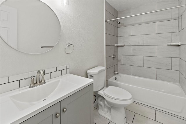 full bathroom with vanity, toilet, and tiled shower / bath combo