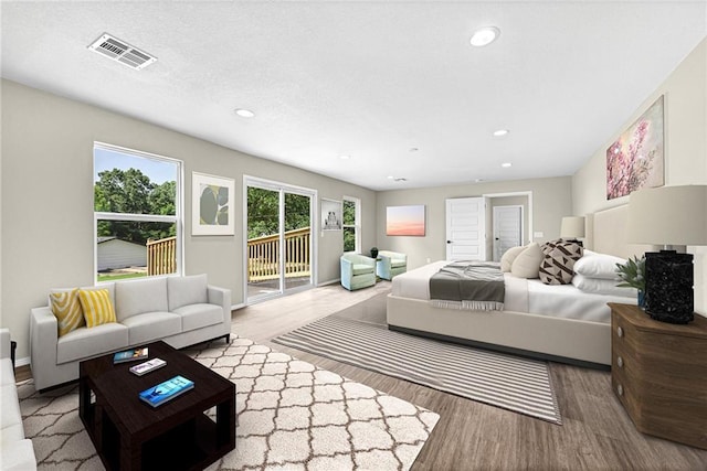 bedroom with access to outside and light hardwood / wood-style floors