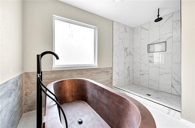 bathroom featuring tiled shower and tile walls