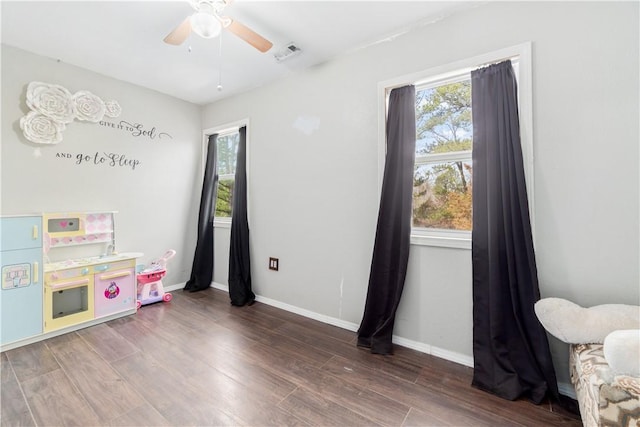 rec room featuring dark hardwood / wood-style flooring and ceiling fan