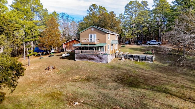 rear view of house featuring a lawn