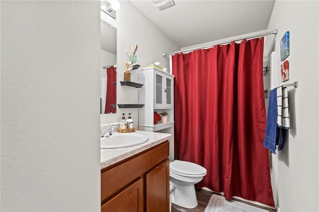 bathroom featuring vanity, hardwood / wood-style floors, curtained shower, and toilet