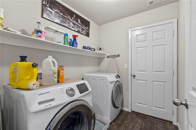 clothes washing area featuring dark hardwood / wood-style flooring and independent washer and dryer