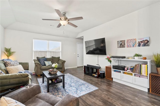 living room with dark hardwood / wood-style flooring, vaulted ceiling, and ceiling fan
